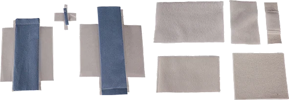 Various sized pieces of grey and blue fabric laid out flat on a surface