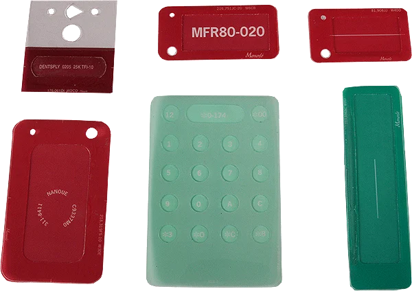 Various red and green industrial nameplates, labels, and a keypad layout