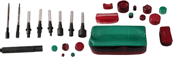 A collection of various mechanical pins, plungers, and red and green caps of different shapes and sizes